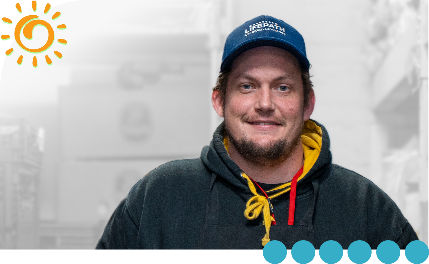This is John. He's smiling and wearing a baseball cap and a sweatshirt.